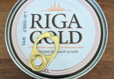 Riga Gold can of sardines seen from above on a wood desk top.